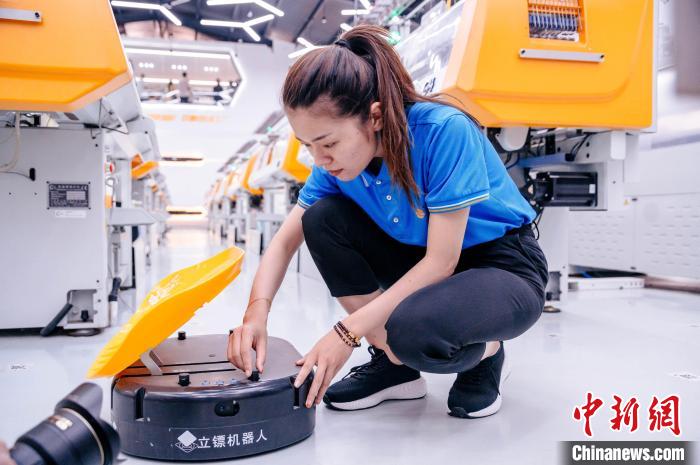 圖為員工在調(diào)試AGV搬運(yùn)機(jī)器人?！±钅宪?攝